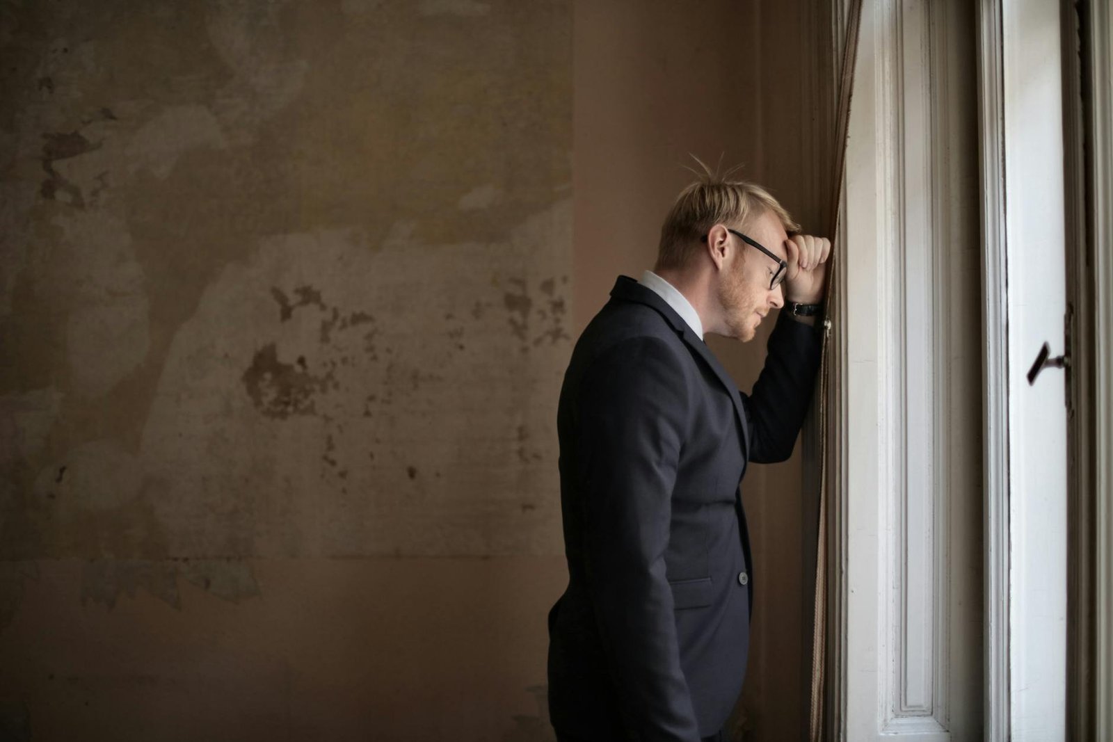 Photo by Andrea Piacquadio on <a href="https://www.pexels.com/photo/desperate-evicted-male-entrepreneur-standing-near-window-3771129/" rel="nofollow">Pexels.com</a>
