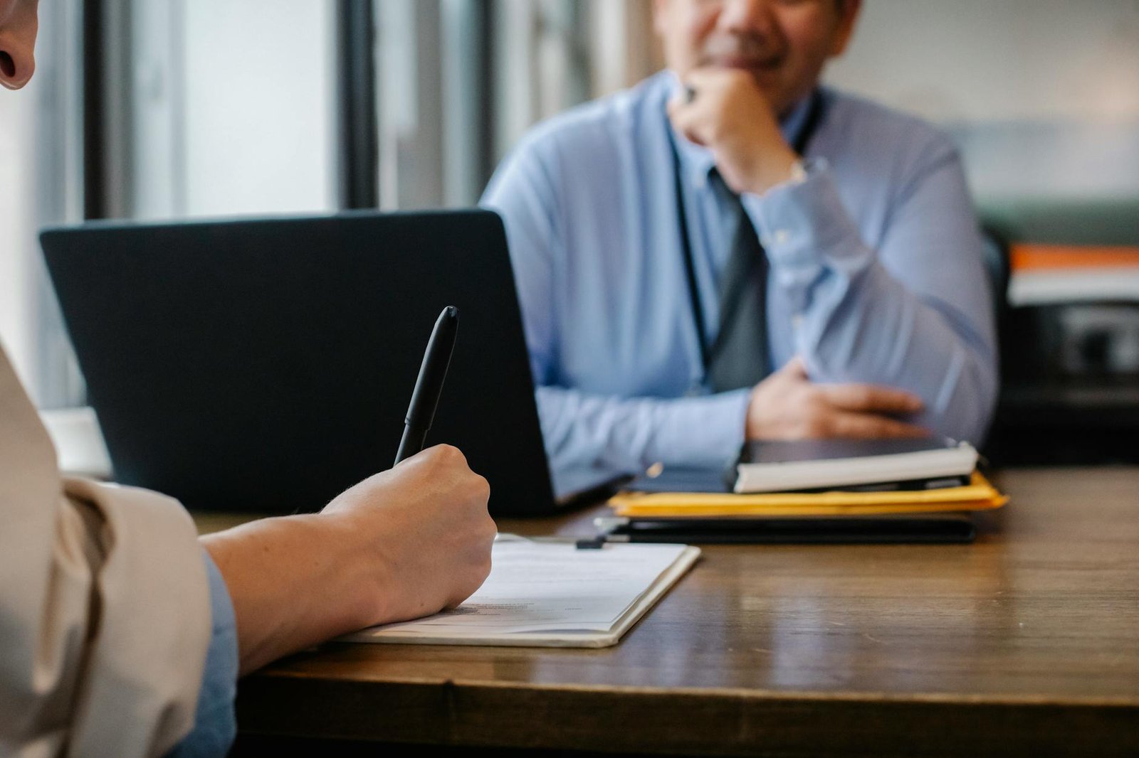 Photo by Sora Shimazaki on <a href="https://www.pexels.com/photo/woman-filling-job-application-form-in-office-with-boss-5668858/" rel="nofollow">Pexels.com</a>