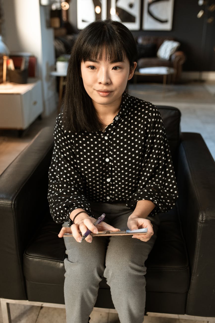 Photo by RDNE Stock project on <a href="https://www.pexels.com/photo/woman-in-black-and-white-polka-dot-long-sleeve-shirt-sitting-on-black-leather-chair-5922538/" rel="nofollow">Pexels.com</a>